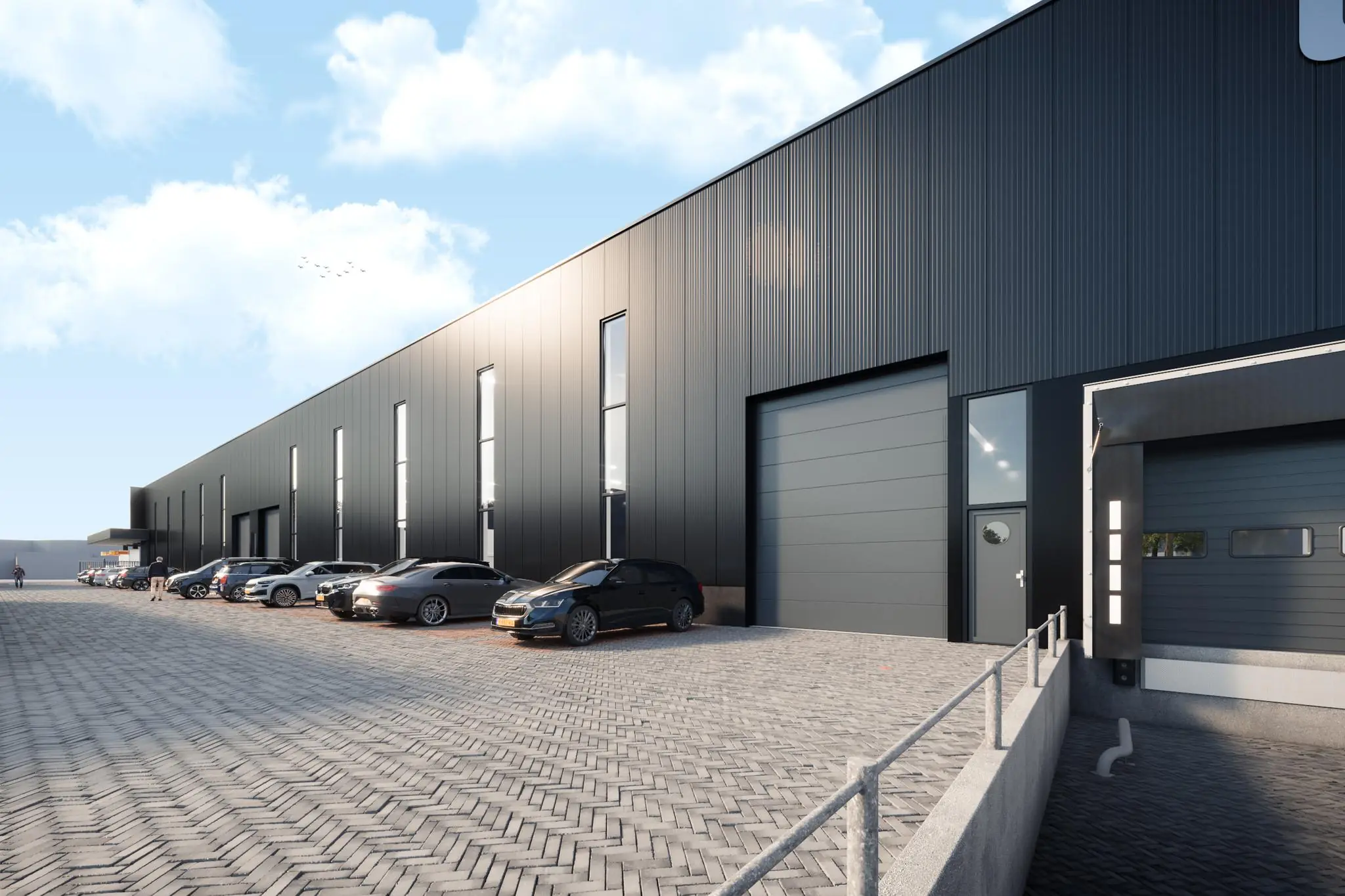 Moderne bedrijfs- en opslagunits aan de Nijverheidsweg met geparkeerde auto's op een bestrate parkeerplaats.