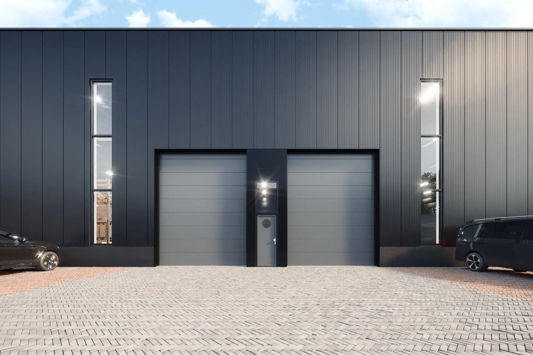 Strakke, moderne bedrijfsunit aan de Nijverheidsweg met twee grote grijze overheaddeuren en smalle hoge ramen.