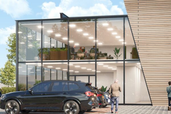 Modern kantoorpand aan de Nijverheidsweg met glazen gevel, geparkeerde auto's en zicht op kantoorruimtes binnen.