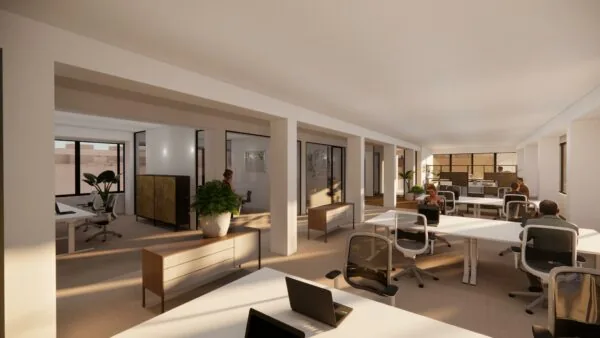 Moderne, open kantoorruimte aan de Volmerlaan met werkplekken, grote ramen en natuurlijk daglicht.