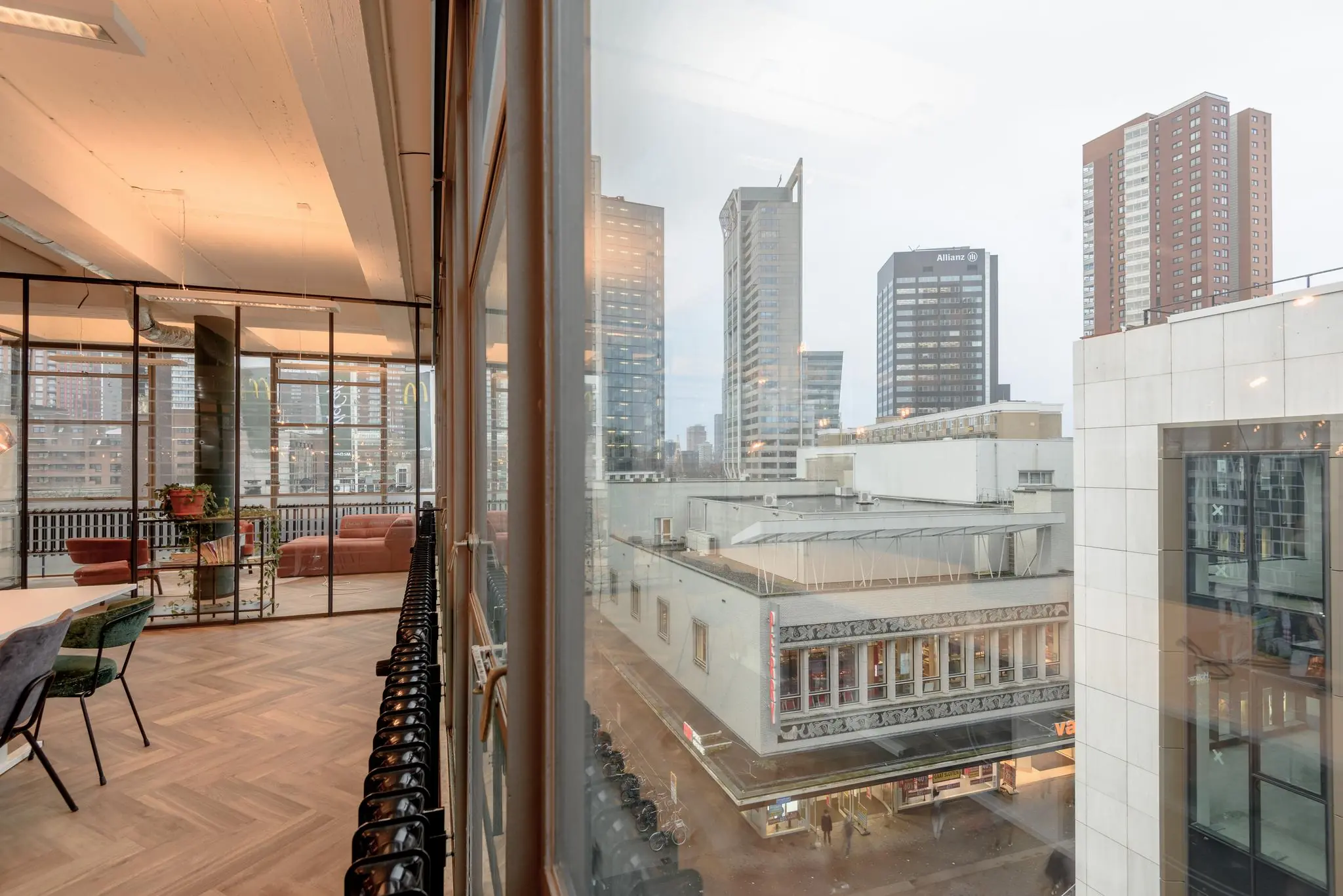 Doorkijk vanuit een modern kantoor aan de Vlasmarkt op het stadscentrum en hoge kantoorgebouwen in Rotterdam.
