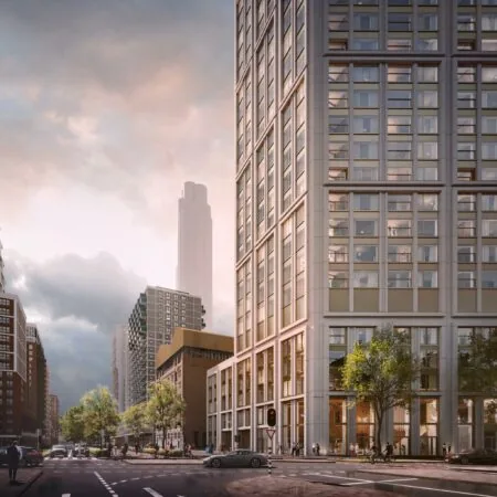 Moderne hoogbouw aan de Rijnhavenkade in Rotterdam bij zonsondergang met verkeer en voetgangers op straatniveau.