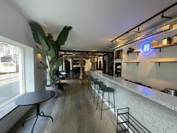 Modern interieur van een sportschool met bar en zitgedeelte aan de Pieter Baststraat.