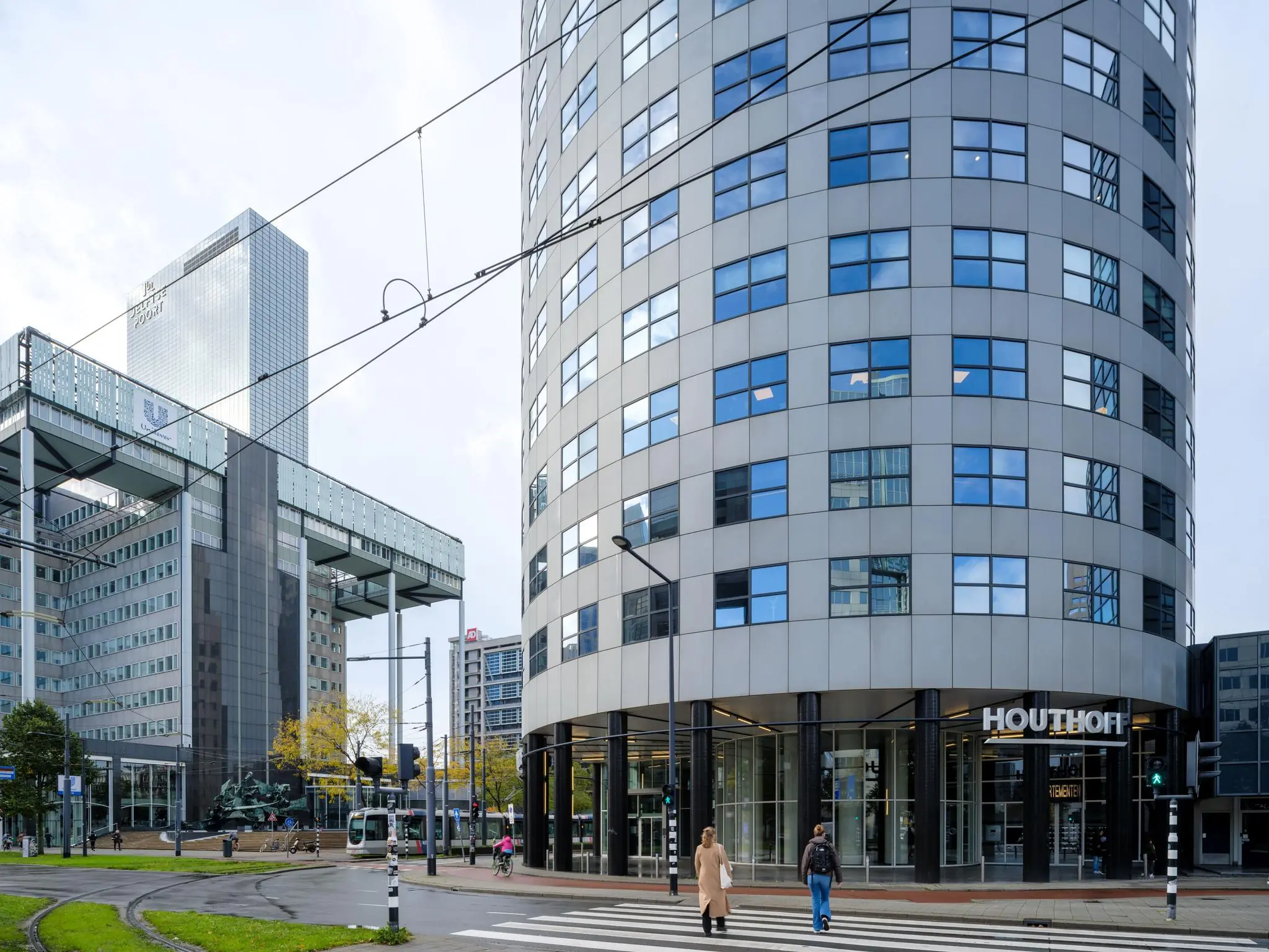 Kantoorgebouw Houthoff aan het Weena in Rotterdam met voetgangers en een passerende tram.