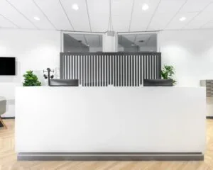 Moderne receptiebalie met strakke witte afwerking in kantoorruimte aan het Capitool 10 in Enschede.