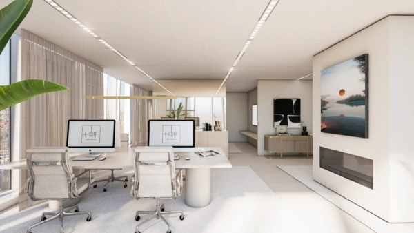 Modern kantoorinterieur aan de Strawinskylaan met strakke bureaus, computers en grote ramen met uitzicht over de stad.