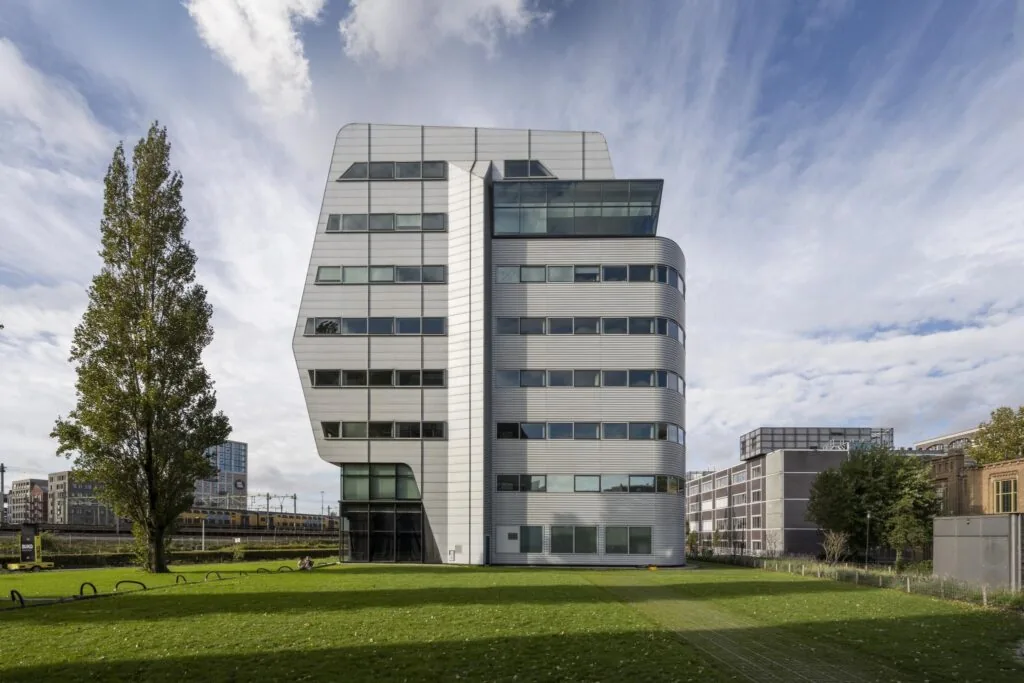 Modern kantoorgebouw aan het Rietlandpark in Amsterdam met een opvallende gevel van metaal en glas.