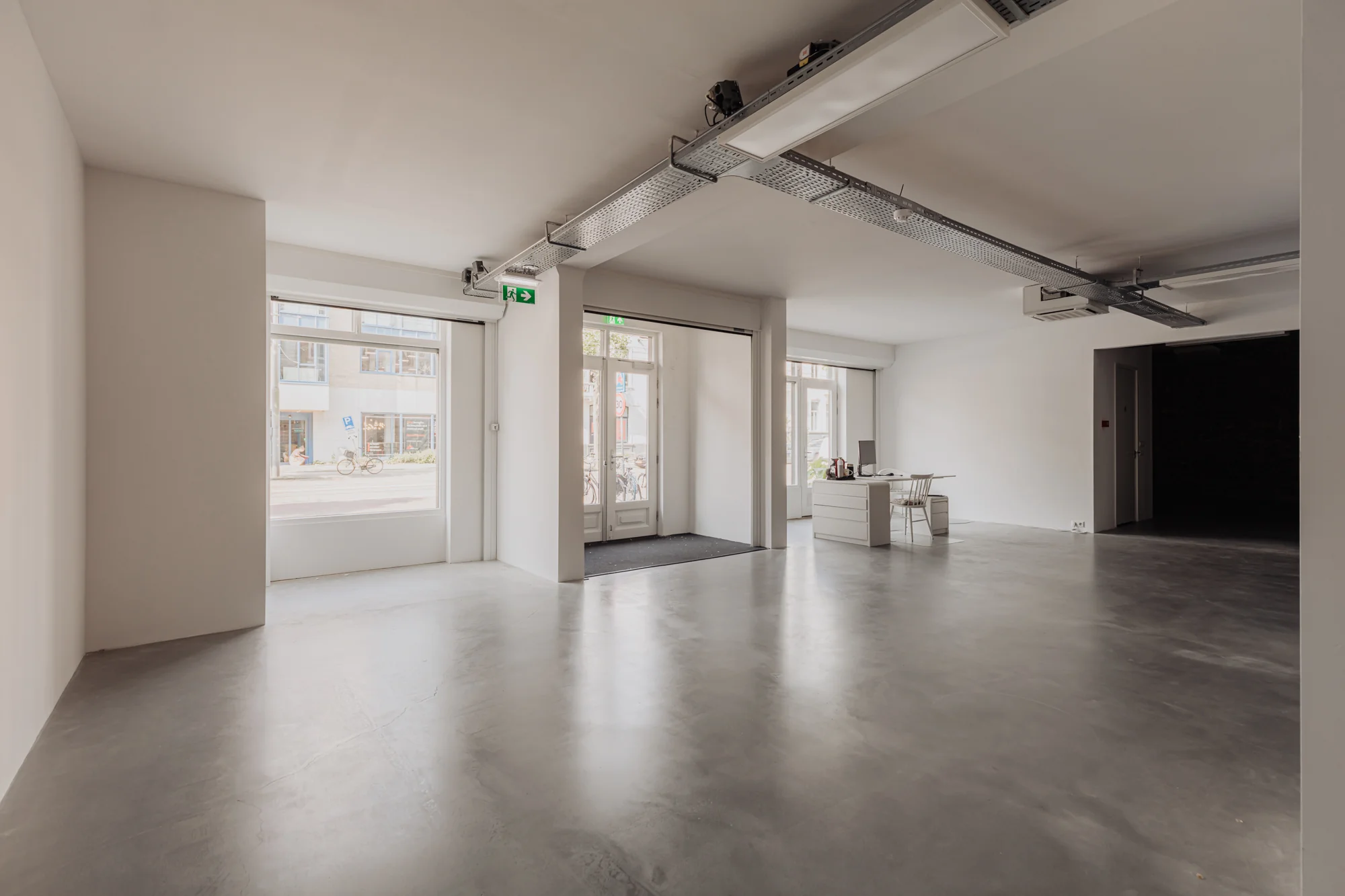 Licht en modern kantoorpand aan de Plantage Middenlaan met grote ramen en een minimalistische inrichting.