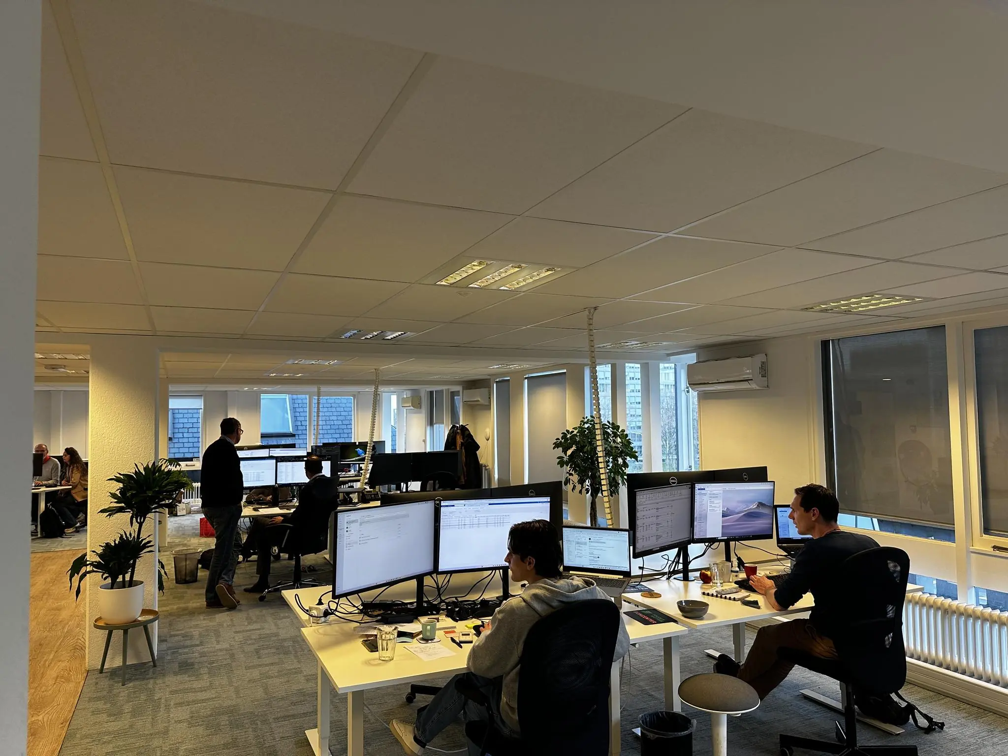 Moderne kantoorruimte aan de Koninginnegracht met meerdere mensen werkend achter computers.