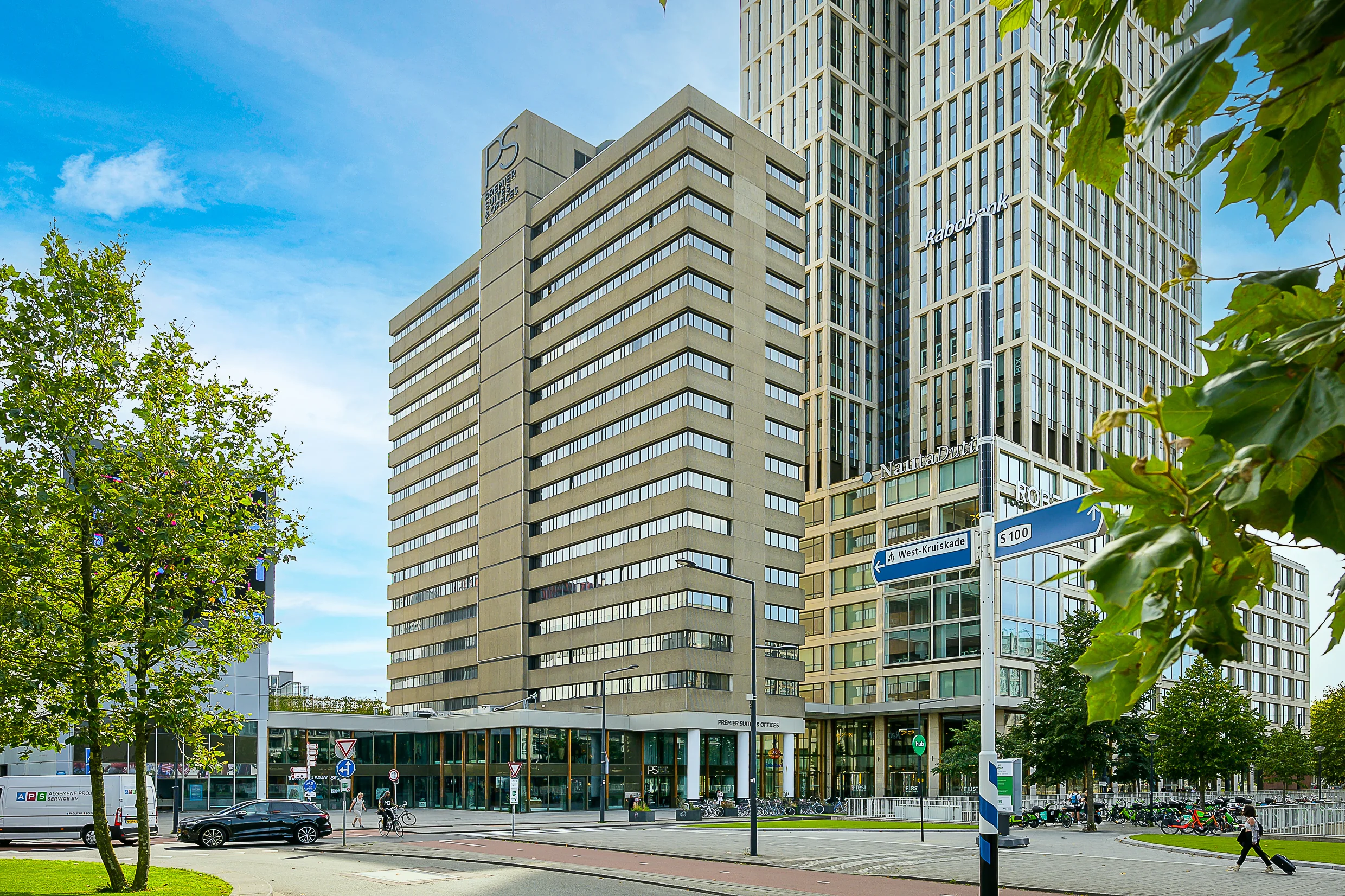 Modern office buildings on Weena street in Rotterdam, including Premier Suites Offices and the Rabobank tower.