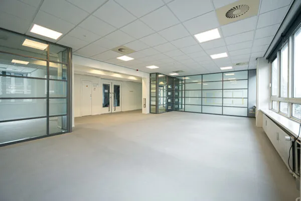 Lichte, lege kantoorruimte met glazen wanden aan de Meent.
