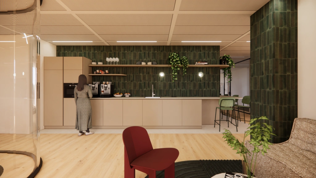 Moderne kantoorkeuken aan de Beethovenstraat met beige kasten, groene tegelwand en een persoon bij het koffieapparaat.