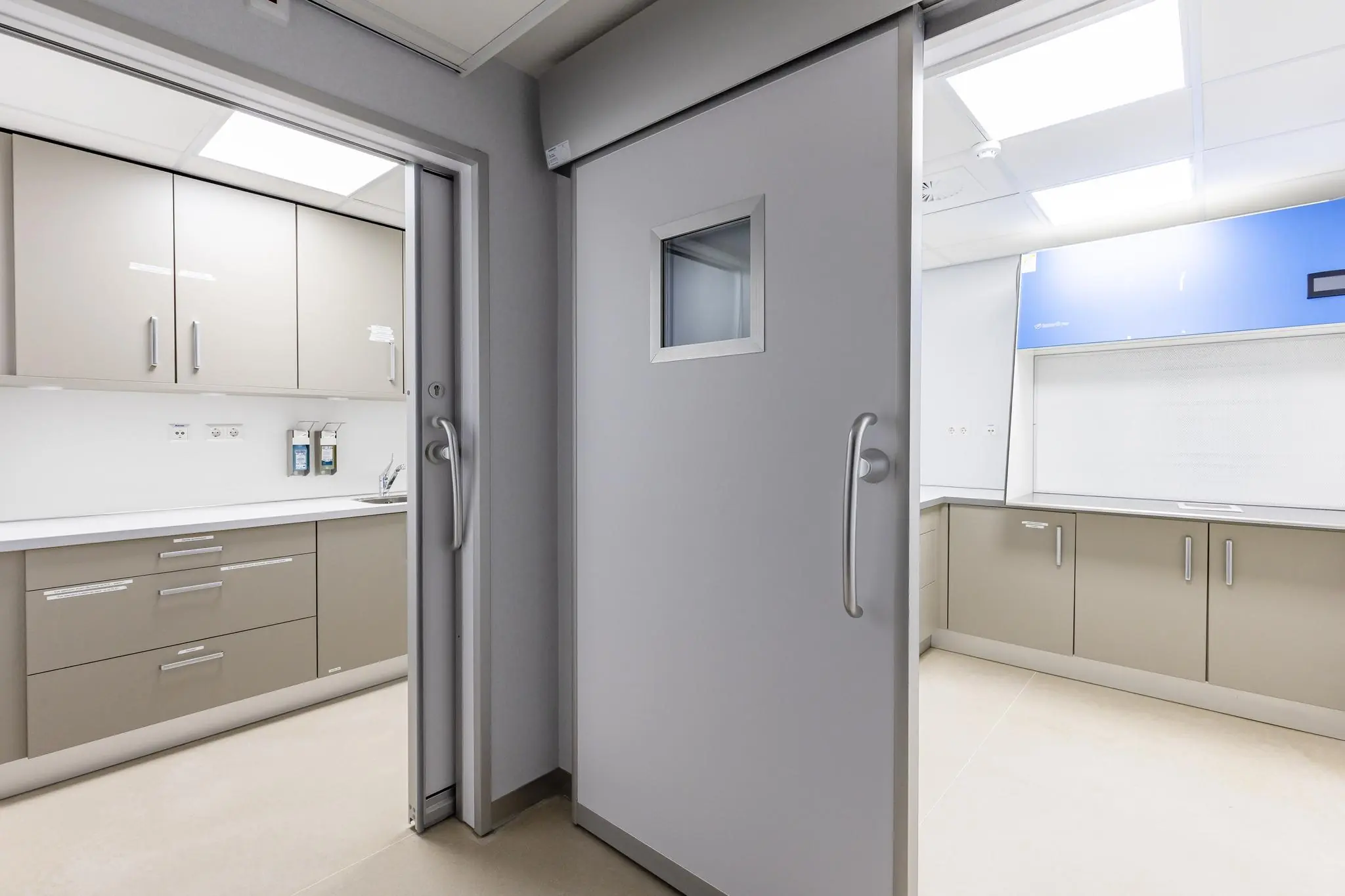 Moderne, steriele ziekenhuisruimte met beige kasten en schuifdeuren aan de 's-Gravenweg.