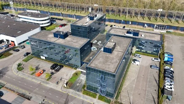 Aerial view of the Essebaan office complex with multiple modern glass buildings and surrounding parking areas.