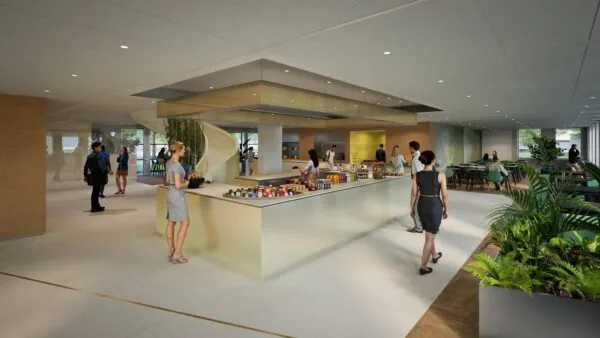 Moderne bedrijfsentree met een open cateringruimte, zithoeken en een wenteltrap, waar mensen informeel samenkomen.