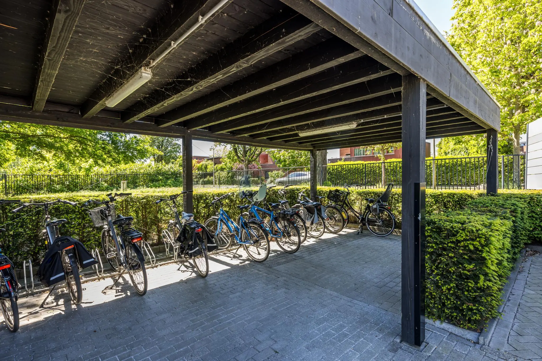 Overdekte fietsenstalling met meerdere fietsen aan de Burgemeester Verderlaan.