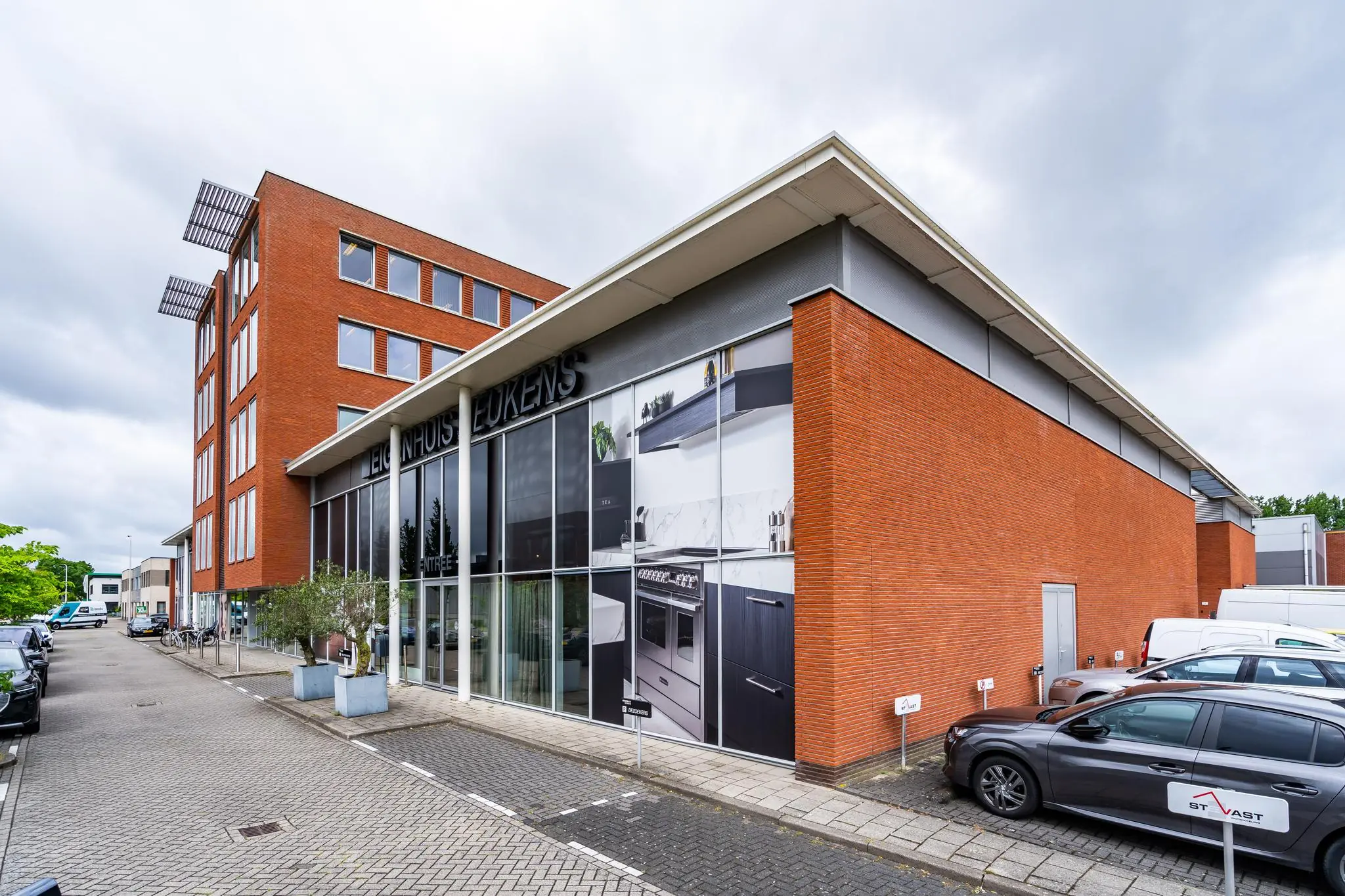 Modern rood bakstenen bedrijfsgebouw aan de Cornusbaan met showroom van 'Eigenhuis Keukens'.