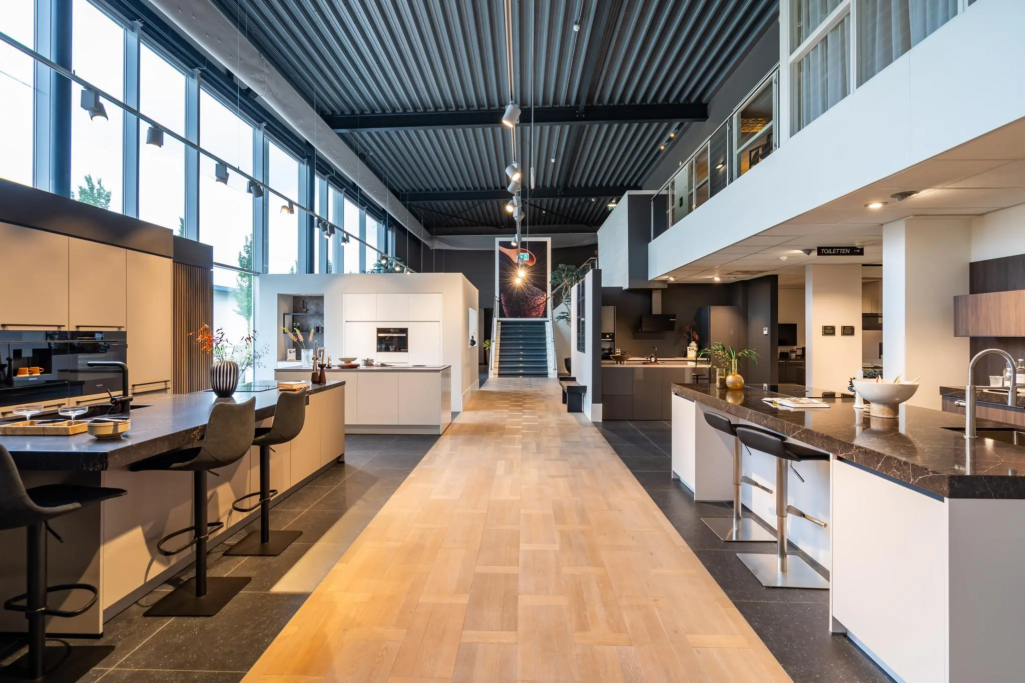 Moderne showroom met diverse keukenopstellingen aan de Cornusbaan, met strakke ontwerpen en stijlvolle afwerkingen.