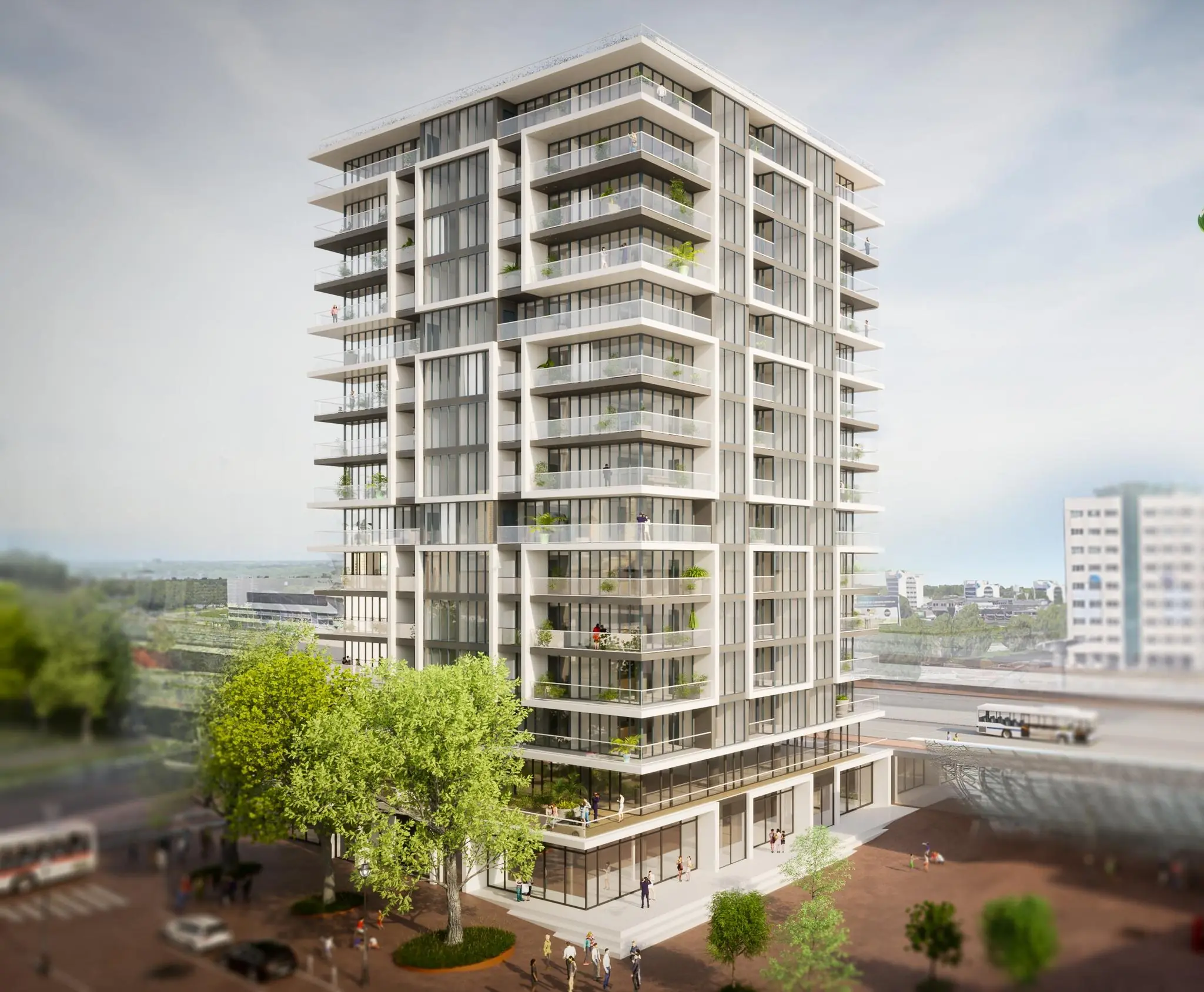 Moderne woontoren aan het Stationsplein met grote balkons en glazen gevels.