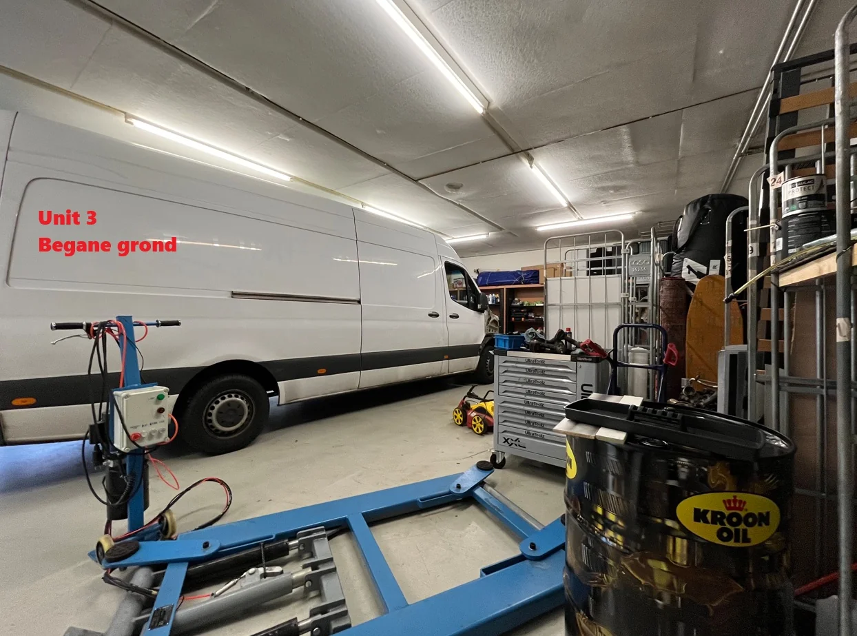 Werkplaats in Unit 3 op de begane grond met een witte bestelbus, gereedschap en een olievat van Kroon Oil.
