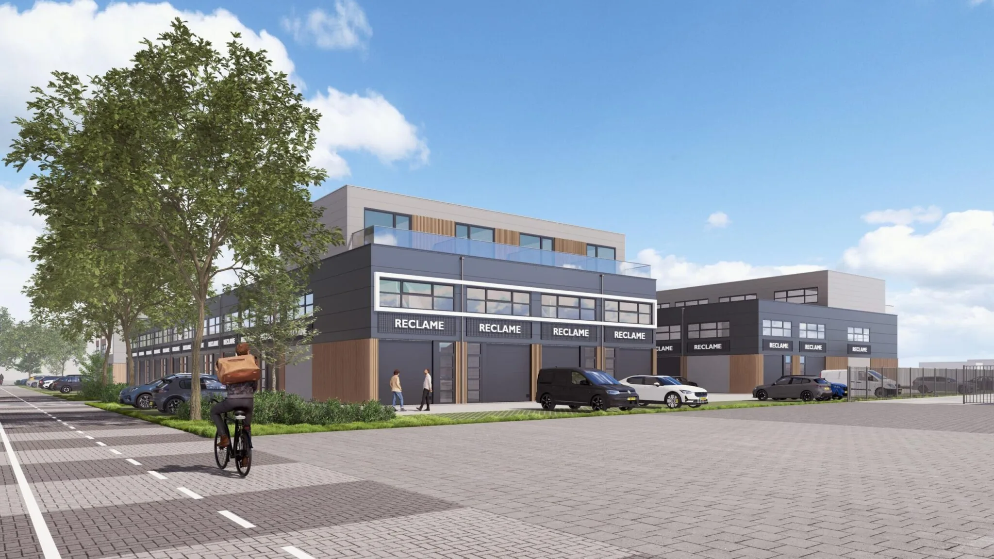 Moderne bedrijfsunits aan De Liesbosch met parkeerplaatsen, groenstrook en een fietser op de voorgrond.