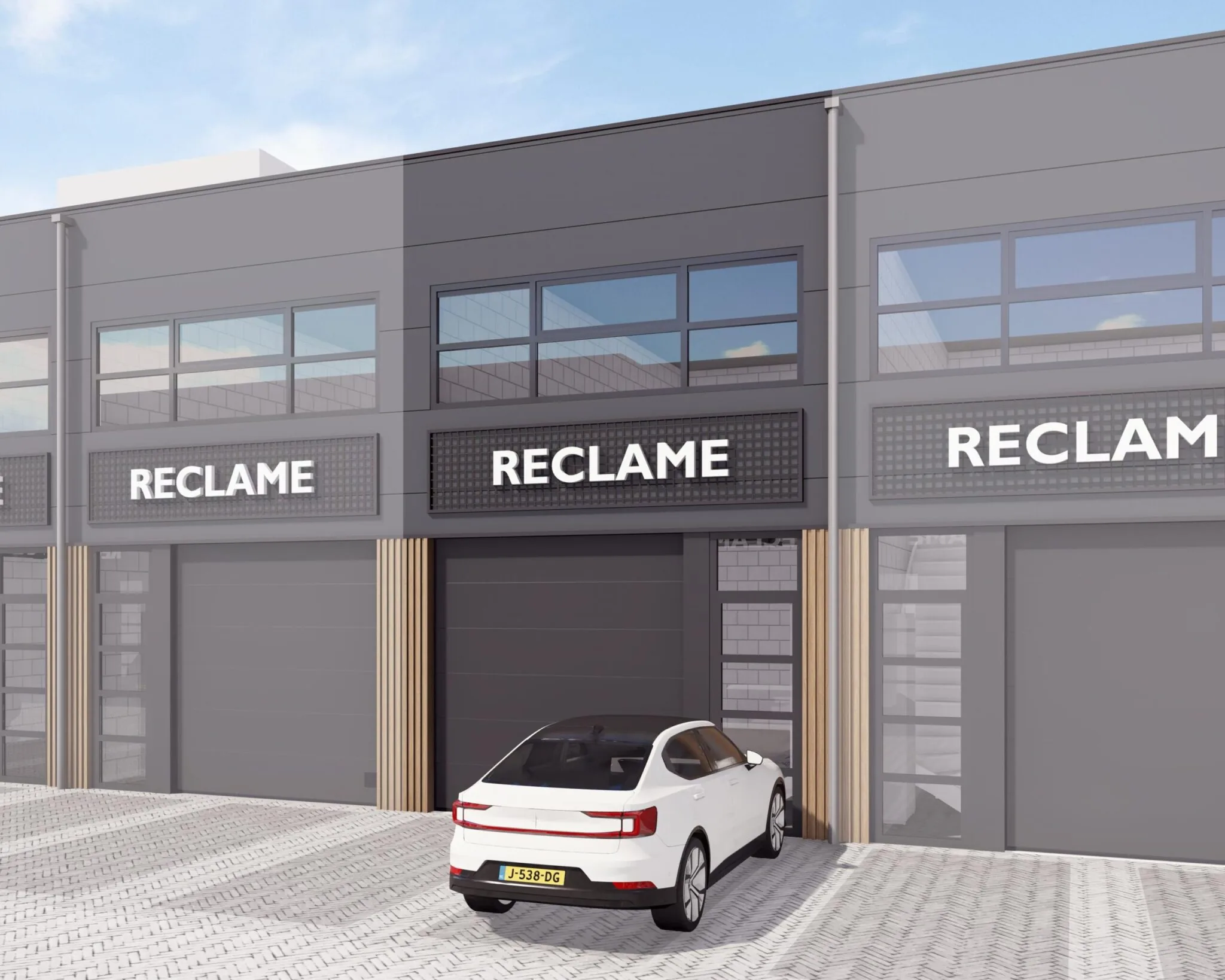 Moderne bedrijfsunits aan De Liesbosch met zwarte gevels, grote ramen en een witte auto op de parkeerplaats.