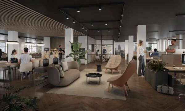 Modern ingerichte kantooruimte aan de Nieuwe Looiersstraat met een open indeling, werkplekken, loungehoek en mensen in overleg.