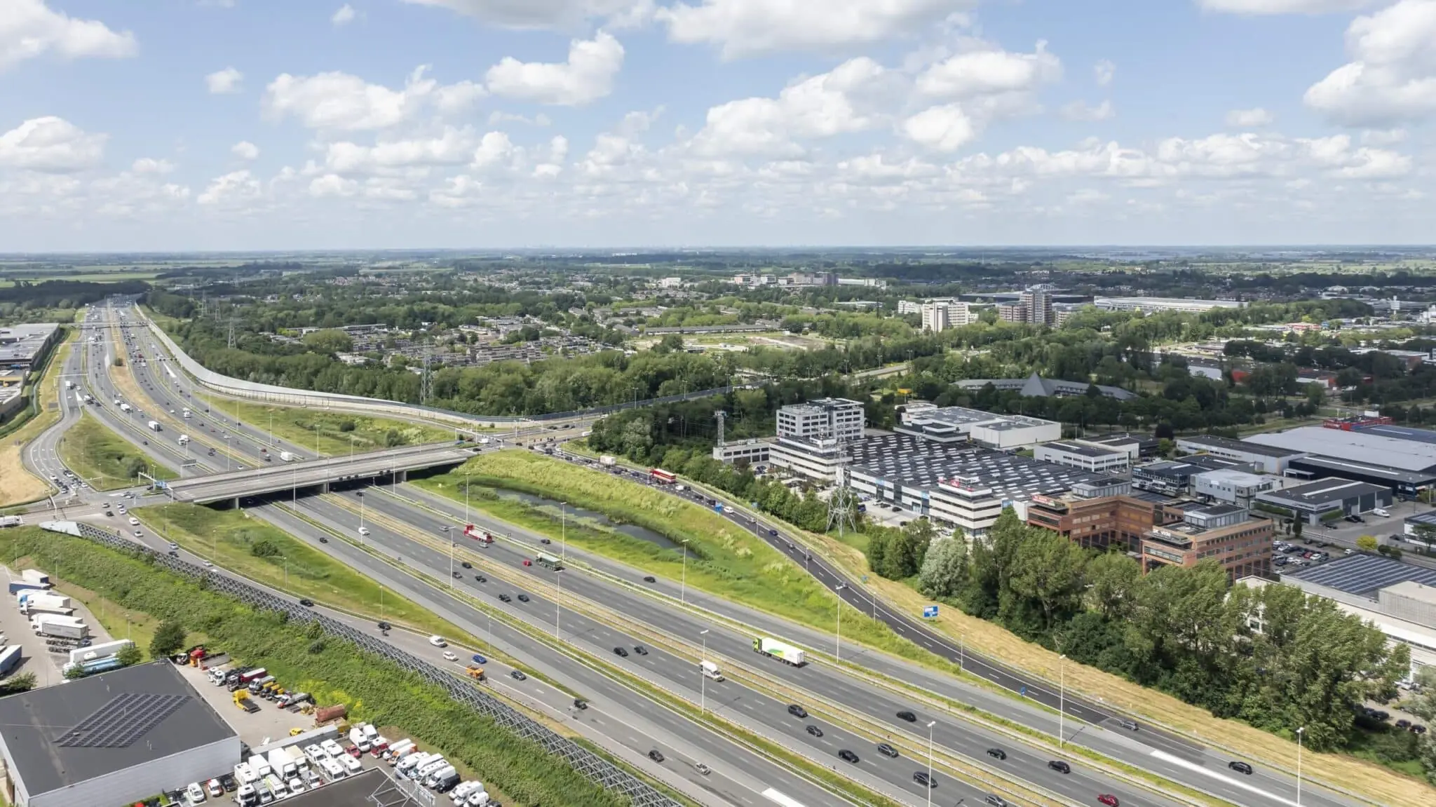Luchtfoto van bedrijventerrein aan de Zonnebaan in Utrecht met zicht op snelwegen en omliggende infrastructuur.