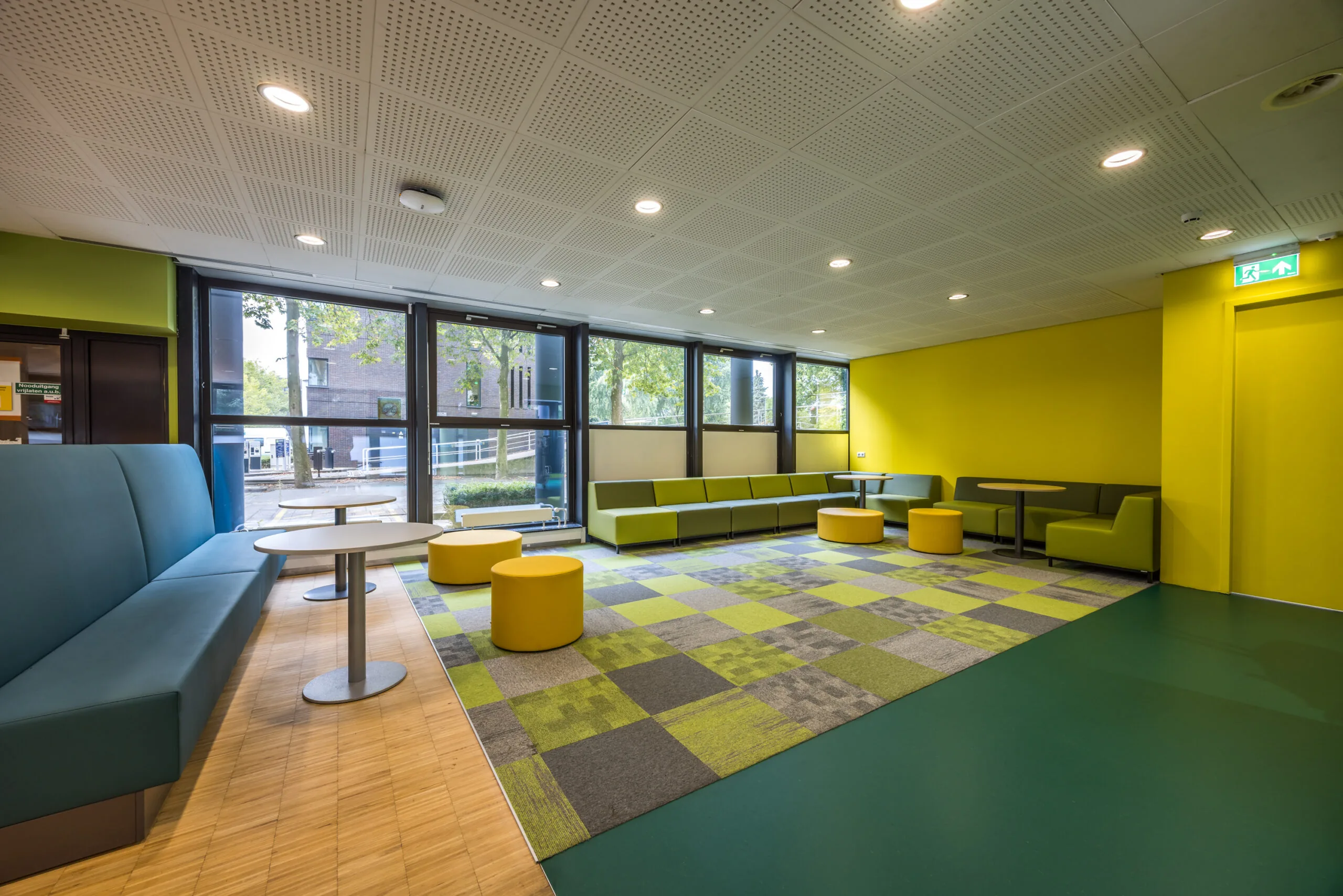 Moderne wachtruimte of lounge met kleurrijk meubilair en grote ramen aan de Daltonlaan.