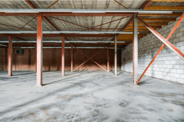 Lege industriële loods aan de Australiëlaan met zicht op betonnen vloer, stalen draagconstructie en onafgewerkte binnenmuren.