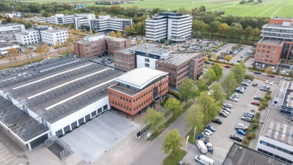 Aerial view of the Veldzigt business complex with office buildings, parking lots, and surrounding green landscape.