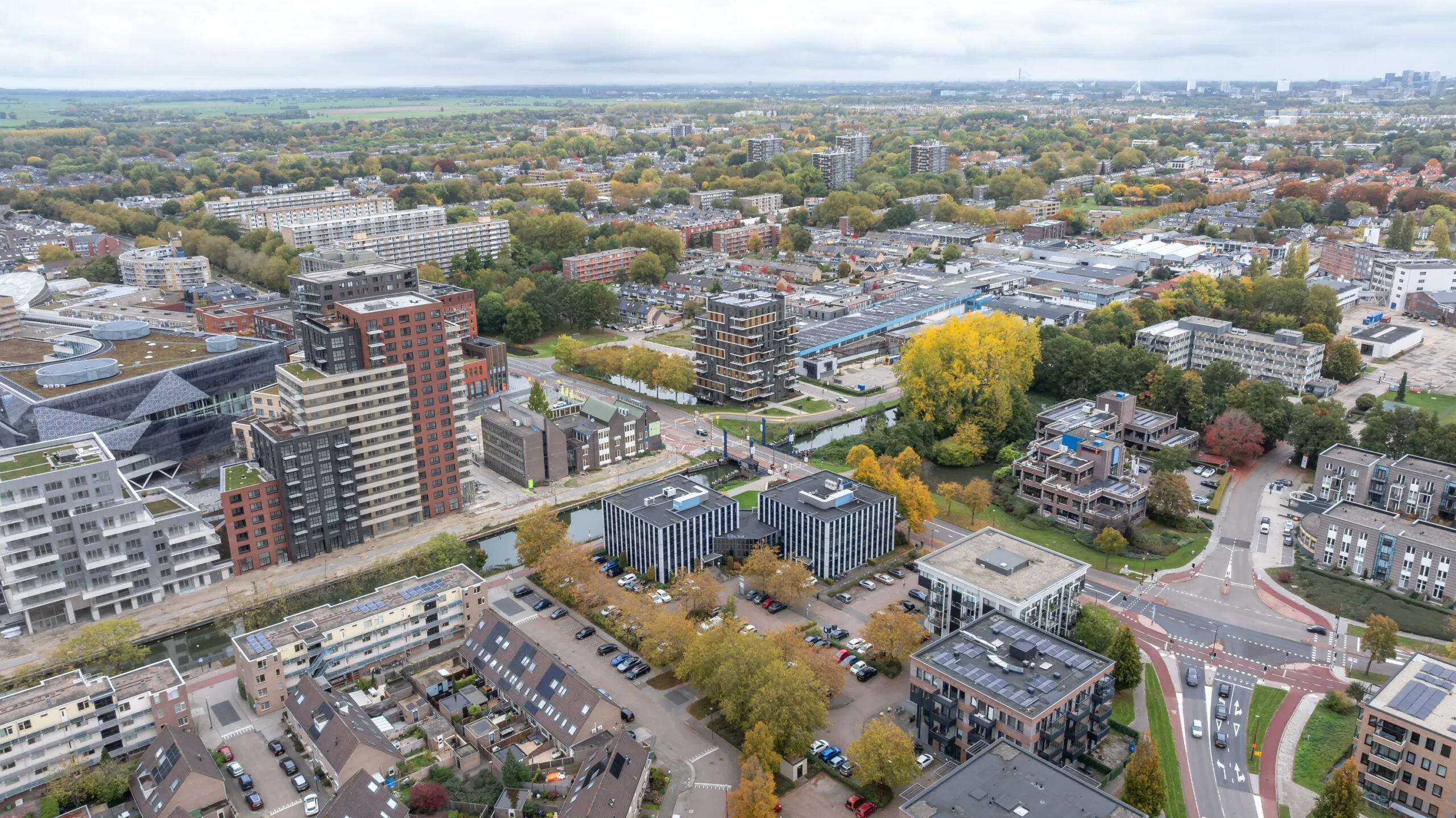 Aerial view of Krijtwal and surrounding modern residential and office buildings in a green urban area.