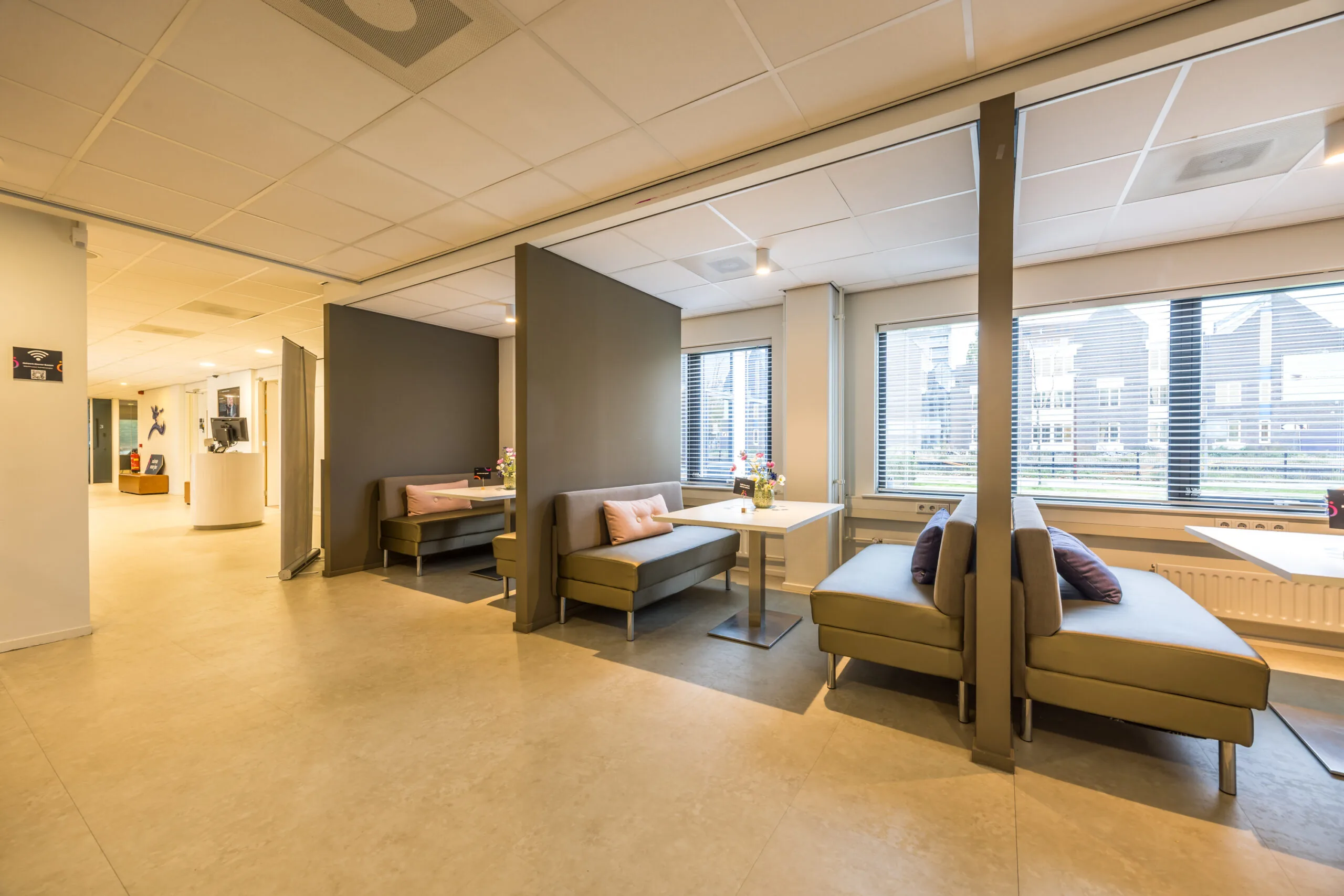 Modern waiting area with partitioned seating booths and large windows at Krijtwal 176.