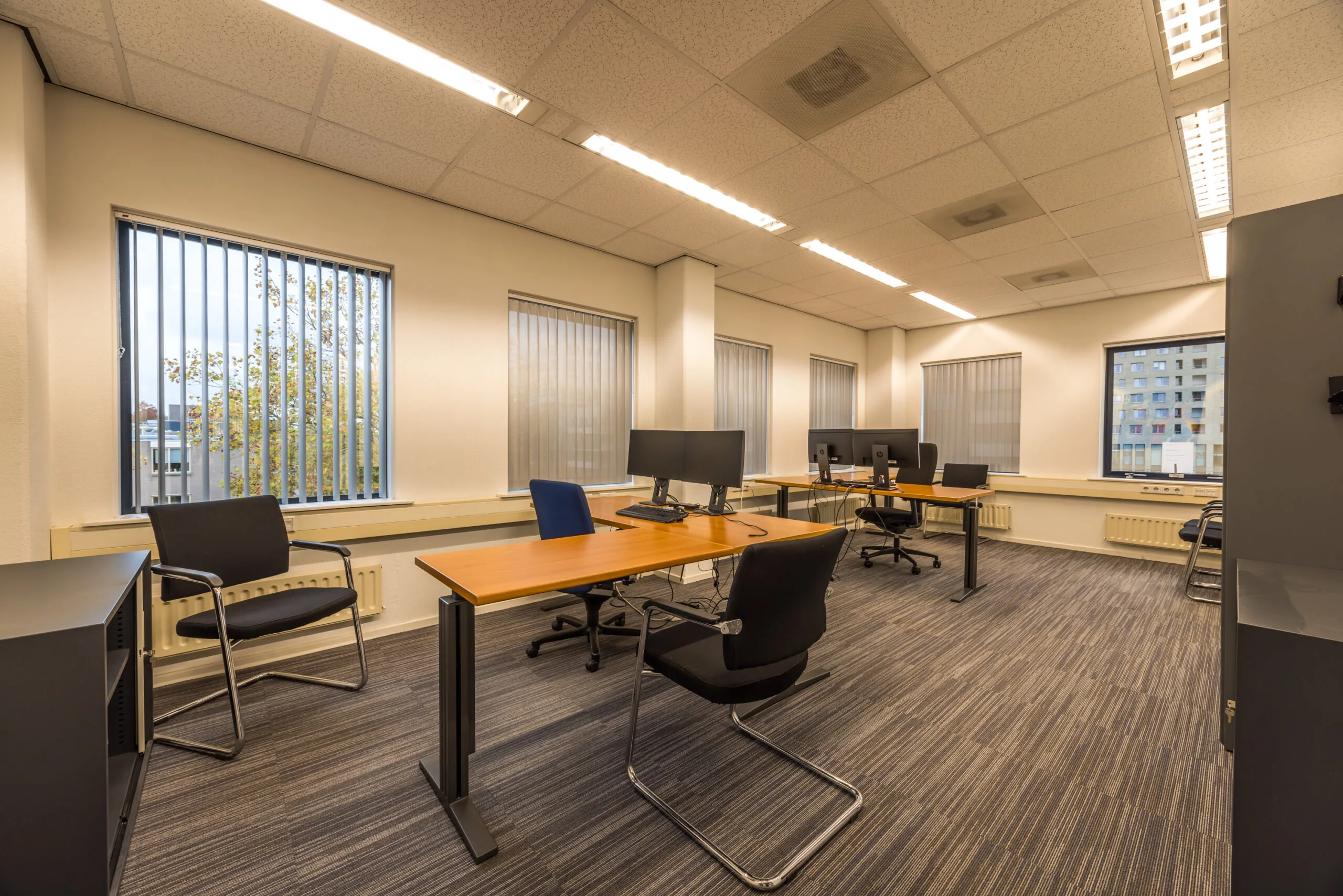 Modern office space on Krijtwal with multiple desks, chairs, and computer workstations.