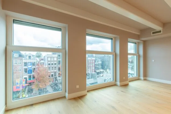 Bright empty room with large windows overlooking Rokin street in Amsterdam.
