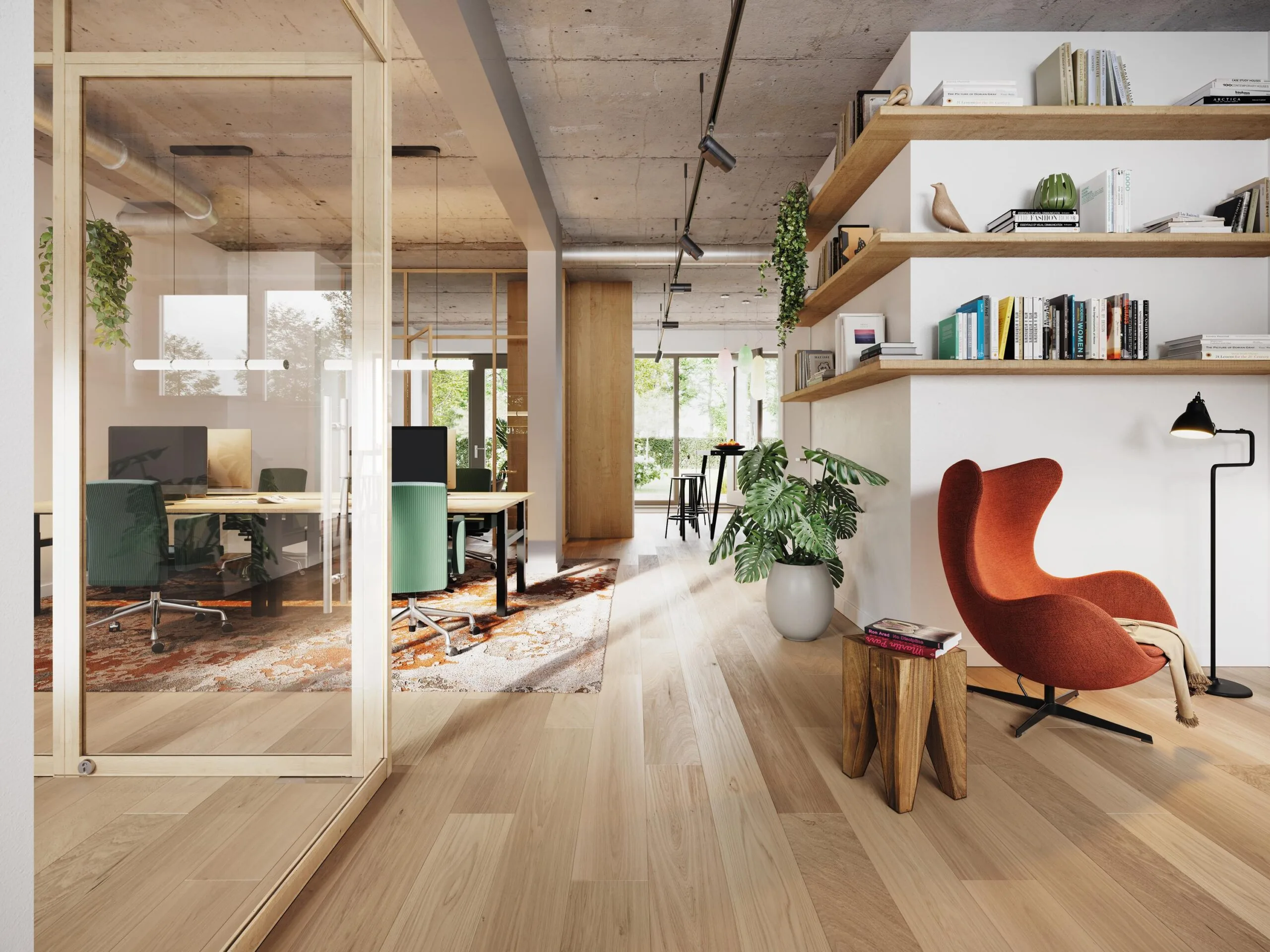 Modern office interior on Zaanstraat with wooden flooring, open workspace, bookshelves, and a red lounge chair.