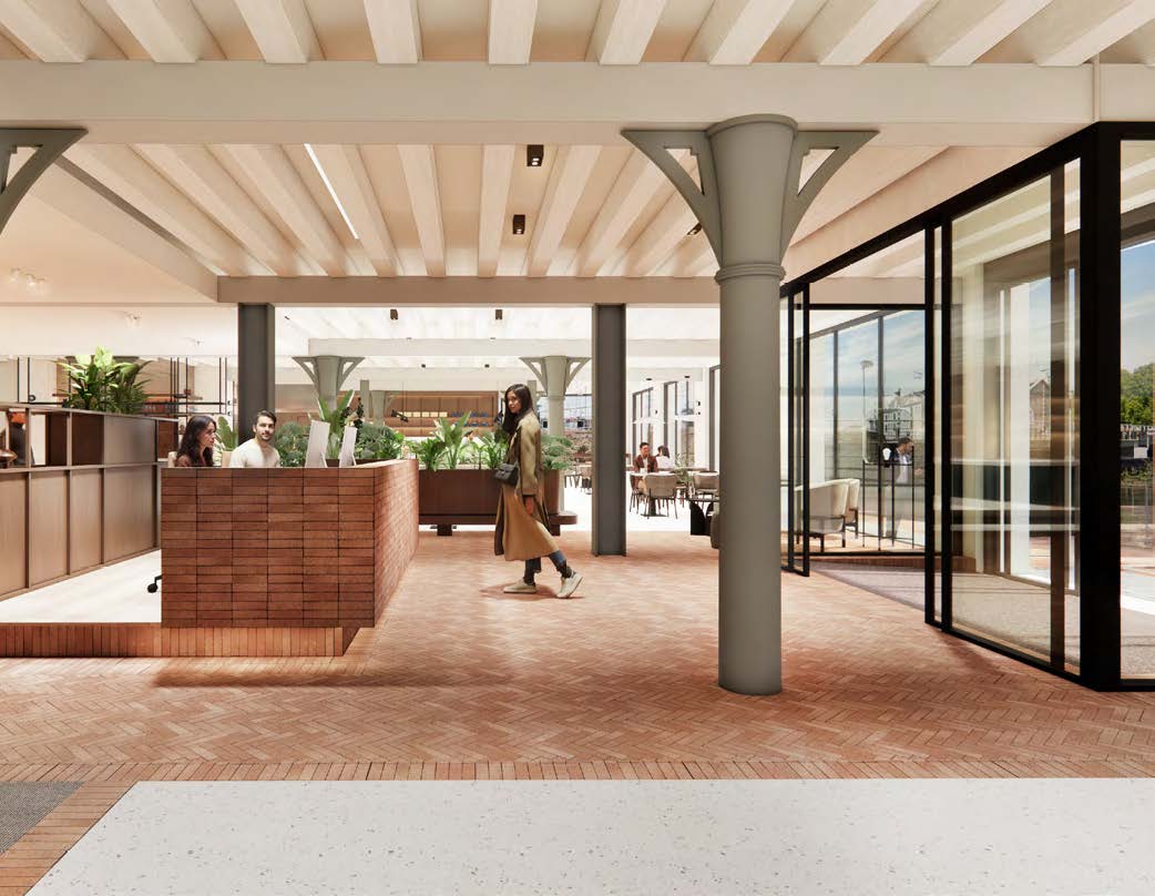 Modern office interior at Nieuwe Vaart with open workspaces, natural light, and people interacting in a welcoming environment.