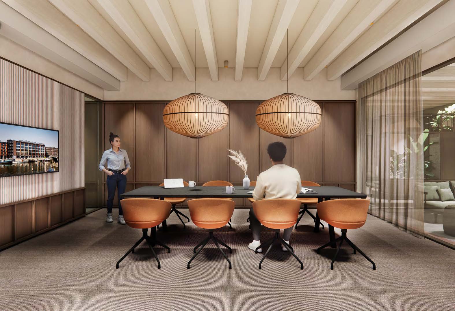 Modern meeting room at Nieuwe Vaart with warm lighting, wooden accents, and two people engaged in a discussion.