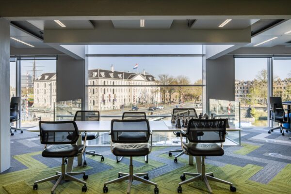 Modern office space with a view of the Dutch National Maritime Museum and the Nieuwe Vaart canal in Amsterdam.