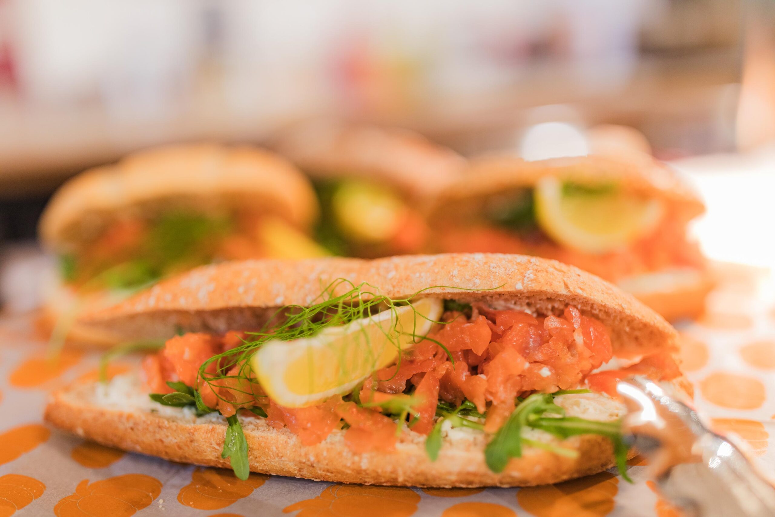 Close-up of fresh salmon baguette sandwiches with lemon and herbs on Hullenbergweg.