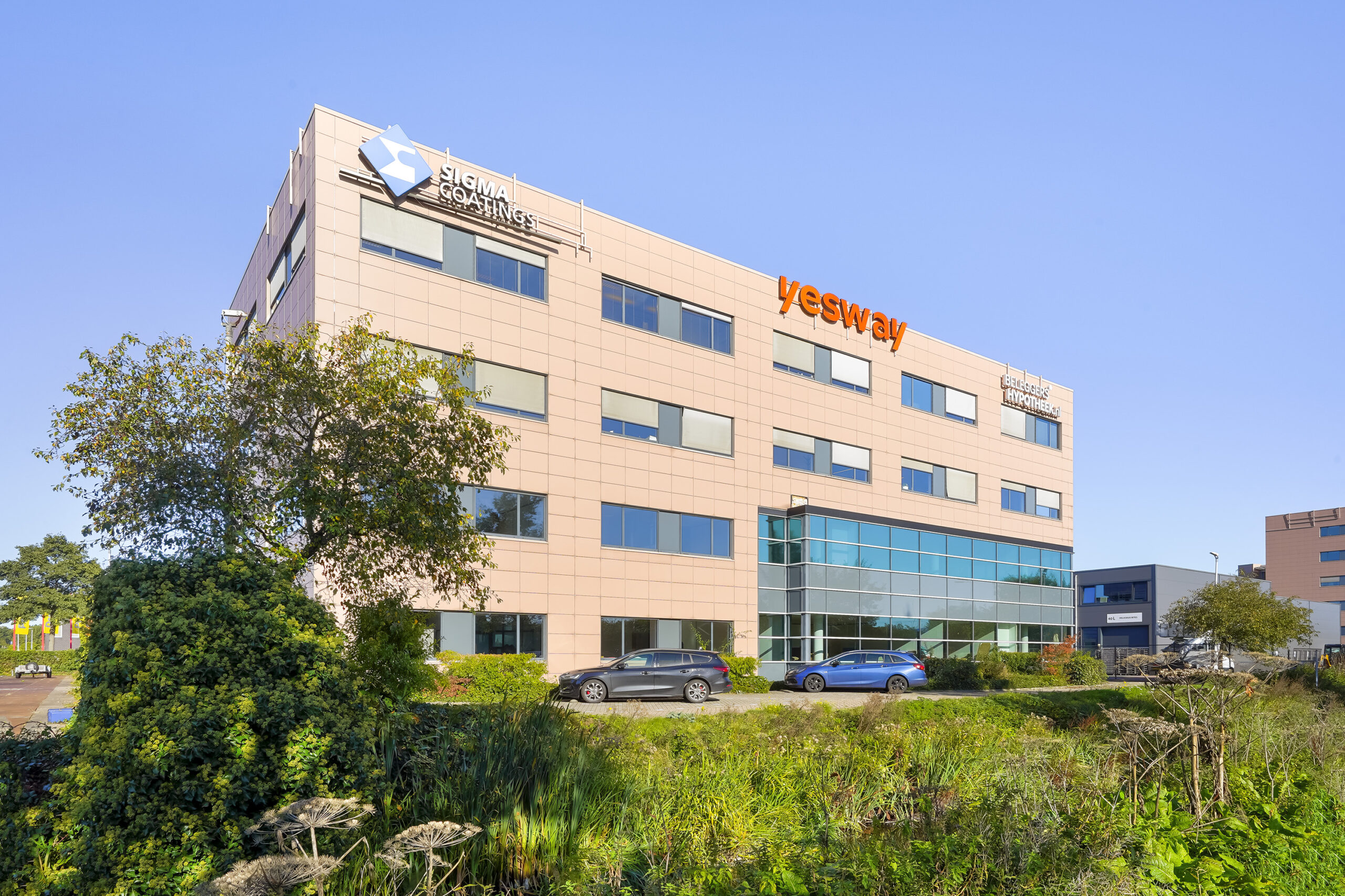 Kantoorpand aan de Laan van 's-Gravenmade met bedrijfsnamen Sigma Coatings, Yesway en De Goede Hypotheken op de gevel.
