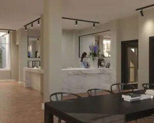 Moderne kantoorruimte met marmeren balie en zithoek aan de Westermarkt 2 in Amsterdam.