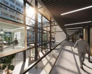 Moderne kantoorruimte met glazen wanden aan de Herikerbergweg 288-290 in Amsterdam, met uitzicht op een lichte gang en omliggende kantoorgebouwen.