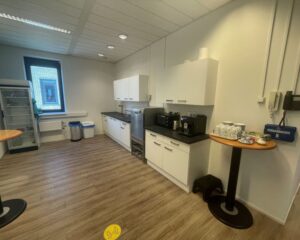 Kantine of pantry in een kantoorruimte aan de Zekeringstraat 17 in Amsterdam met keukenblok, koffieapparaat, koelkast en servies.