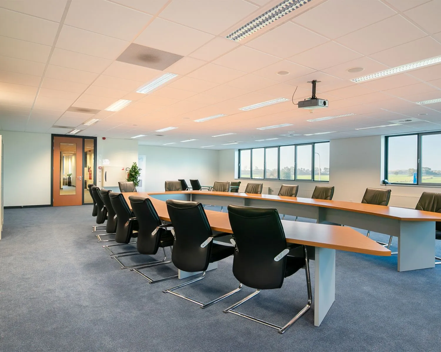 Moderne vergaderruimte met grote U-vormige tafel en comfortabele stoelen aan de Carlsonstraat 13 in Kampen.
