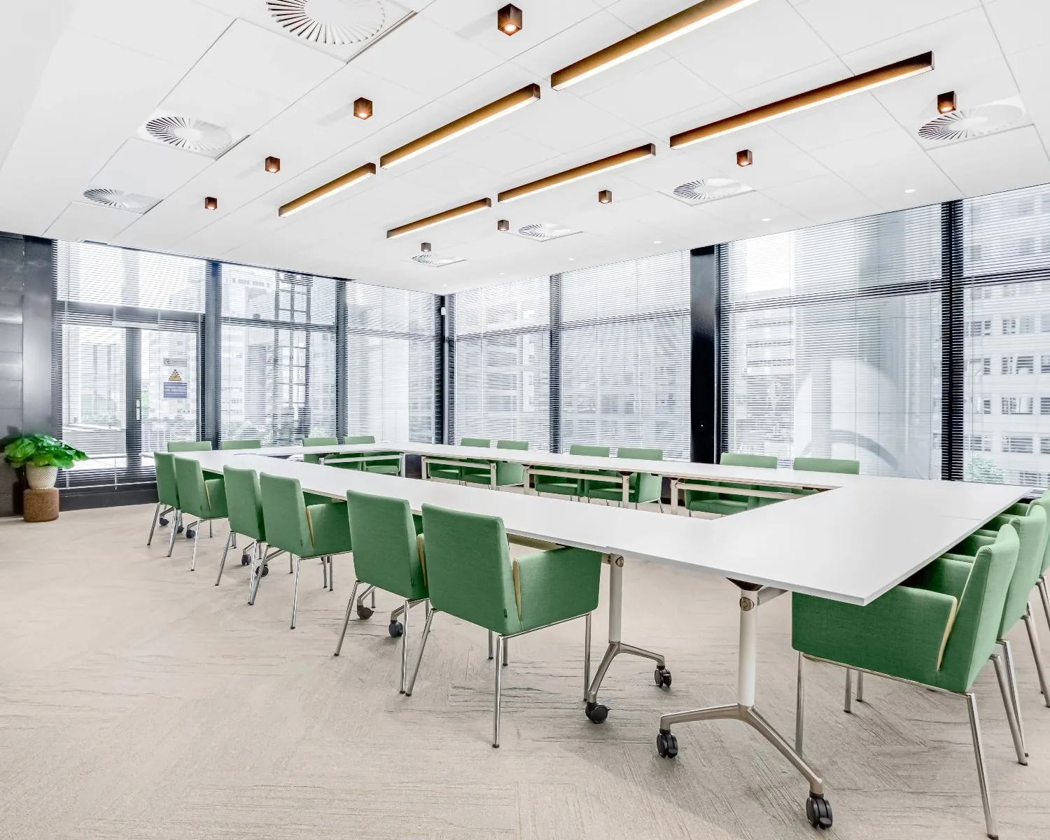 Lichte en moderne vergaderruimte met groene stoelen in de Delftse Poort aan het Weena 505 in Rotterdam.