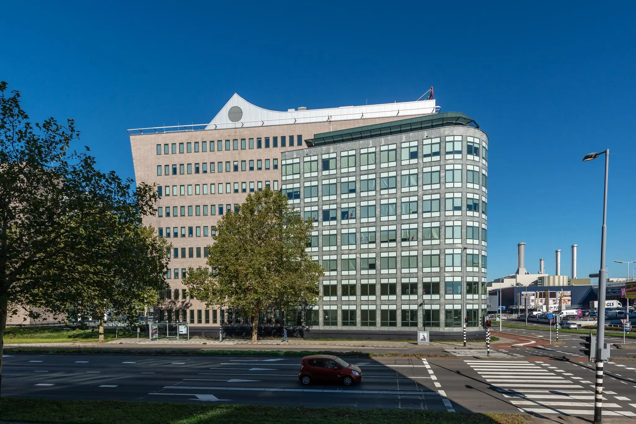 Kantoorgebouwen aan de Watermanweg in Rotterdam, gezien vanaf de overkant van de straat op een zonnige dag.