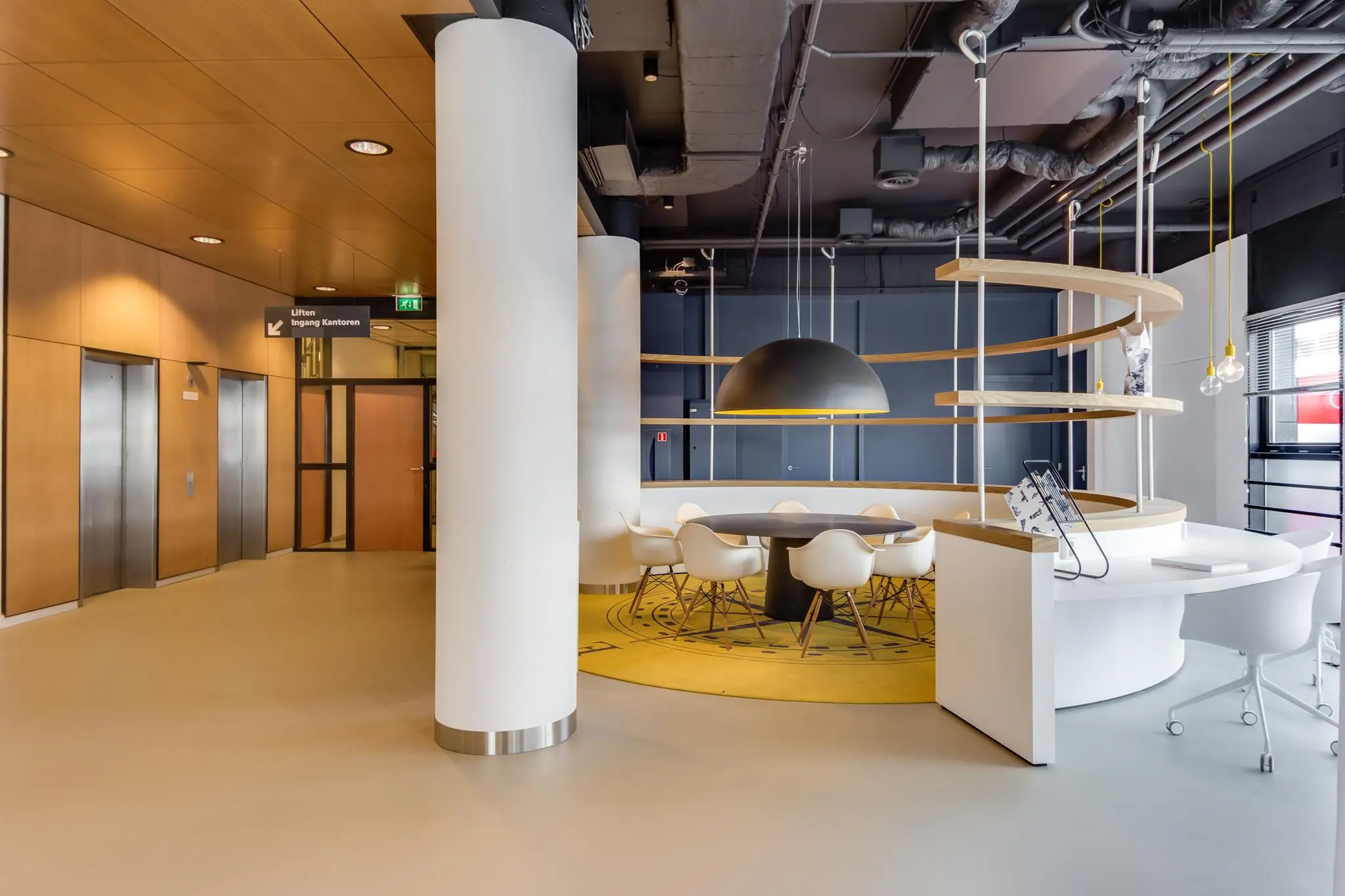 Moderne wachtruimte met designmeubilair en gele accenten op het Willemsplein.
