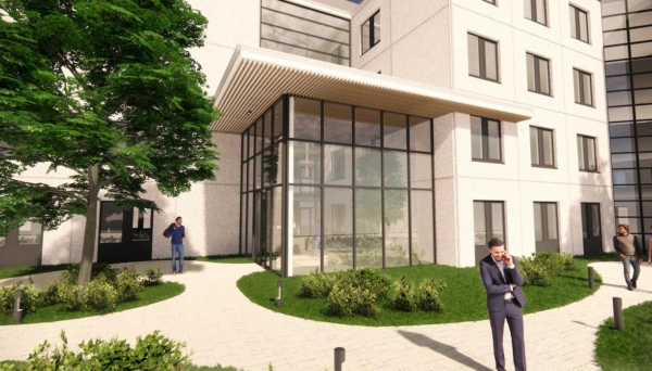 Ingang van het moderne kantoorgebouw Rijnzathe met glazen gevel en omringende wandelpaden en beplanting.