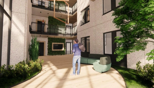 Moderne en lichte binnentuin van het kantoorgebouw Rijnzathe met groene wanden, houten accenten en bezoekers.